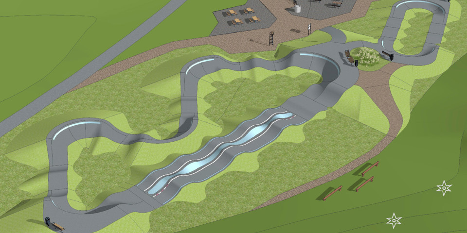 Asfaltsbana i oval form med höjdskillnader, omgivande grönområde, illustration.
